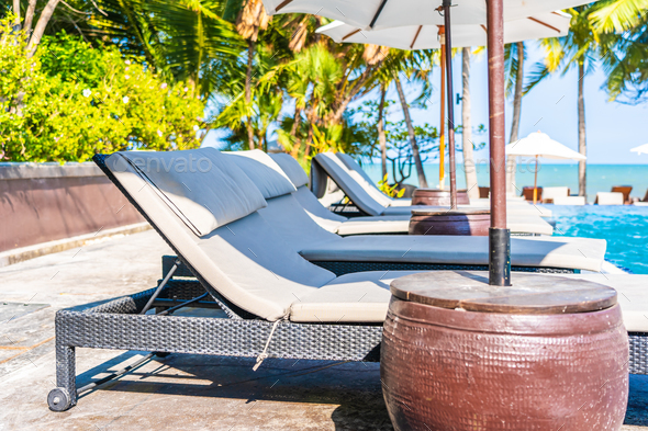 Umbrella And Chair Around Swimming Pool In Hotel Resort Neary Se