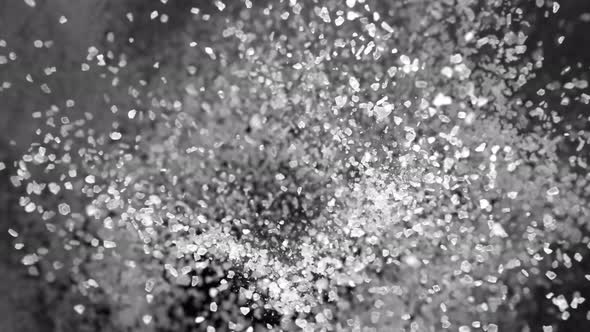 Super Slow Motion Shot of Salt Explosion on Black Background at 1000Fps. alt