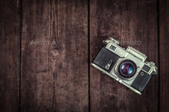 Old vintage camera closeup on wooden background Stock Photo by ©Plus69  71375685