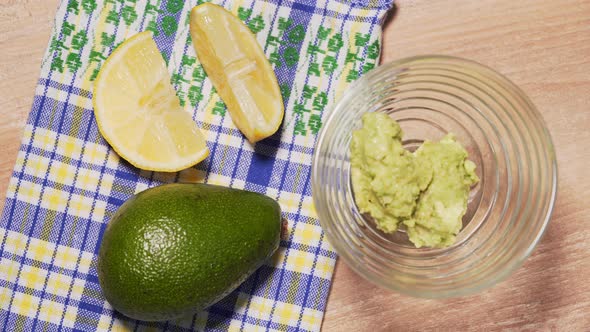 Guacamole Recipe, Final Step. The Chef Puts the Ready-made Guacamole in a Transparent Plate, on a