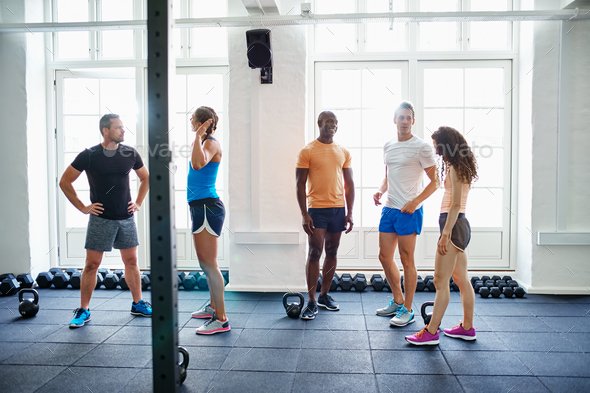 Diverse group of people talking together after a gym workout