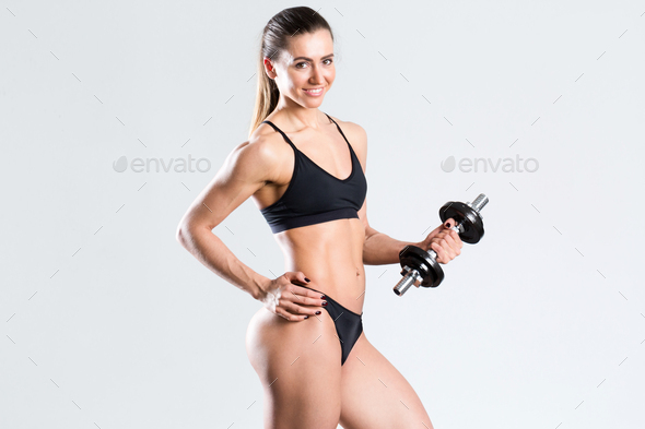 Woman with dumbbell fit slim abs body.