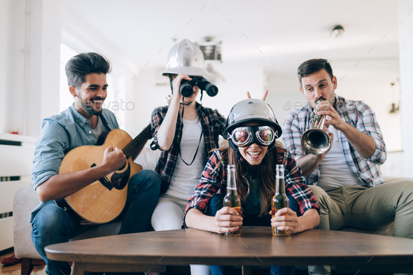 Group of happy young friends having fun and drinking beer - Stock Photo - Images