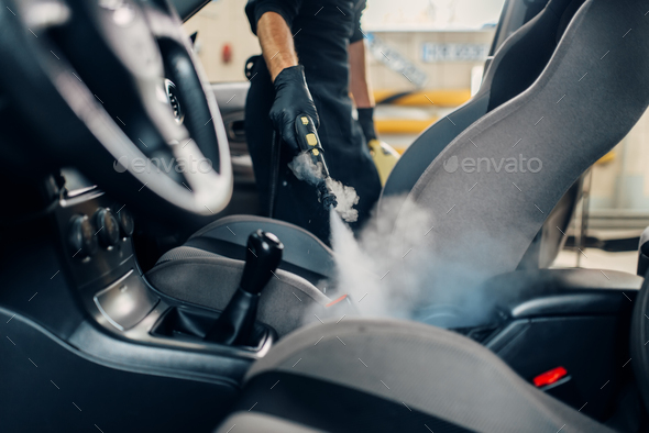 Carwash Worker Cleans Seats With Steam Cleaner