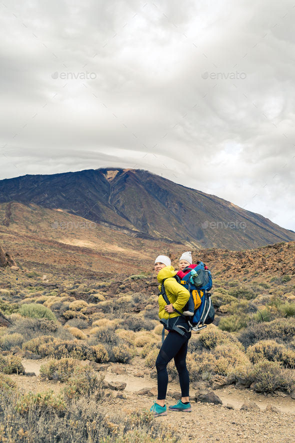 Happy mother with little boy travelling in backpack - Stock Photo - Images