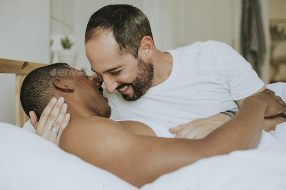 Gay couple making out in bed