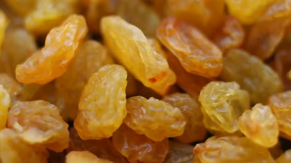 Rotating background of yellow raisins