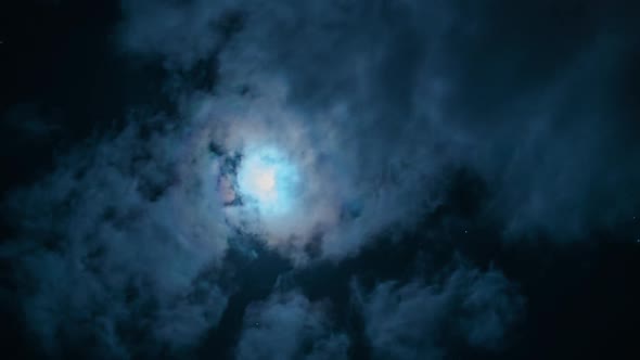 Dramatic Moon Shines Through Clouds