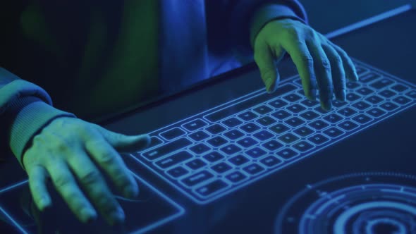 Closeup of a Hacker's Hands Typing Text on a Touch Keyboard alt