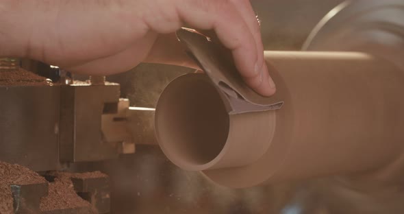 Man working on a wood lathe creating art - slow motion macro shot alt