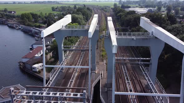 Railway bridge over river Vecht in Holland in the city of Weesp, aerial alt