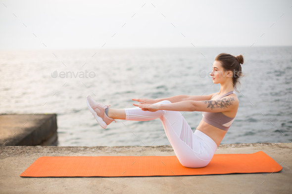 Slim beautiful women practices yoga poses on the mat beside a lake at the  outdoor park with green grass background. Yoga and life health concept wit  Stock Photo - Alamy