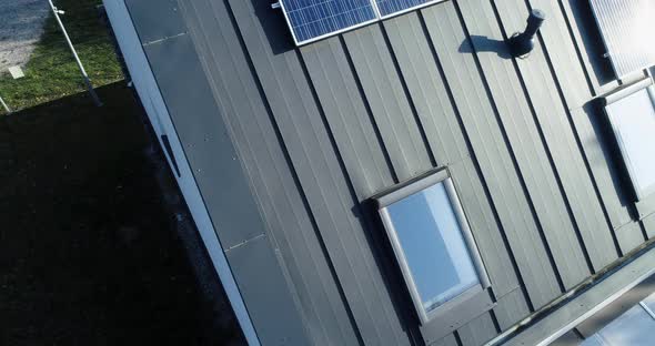 Slide over new house with solar panels surrounded by nature. alt