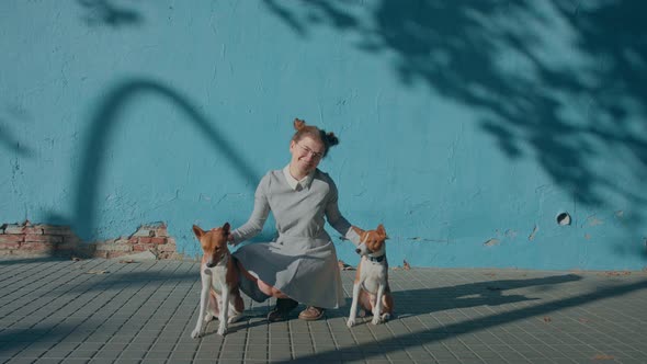 Young Pretty Woman Breeder with Two Basenji Dogs alt