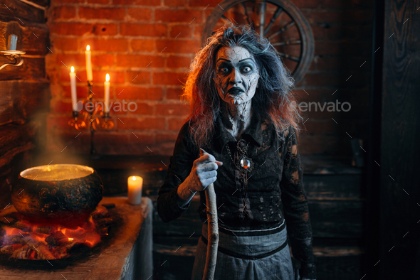 Scary witch on spiritual seance, cooking - Stock Photo - Images