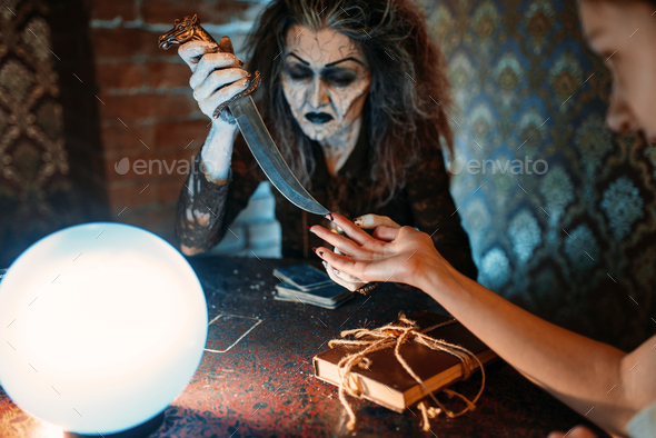 Scary witch with knife, spiritual seance - Stock Photo - Images