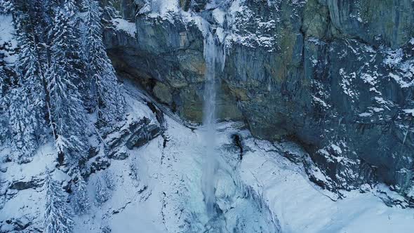 Slow Motion Waterfall Over Rocks in Winter Mountains