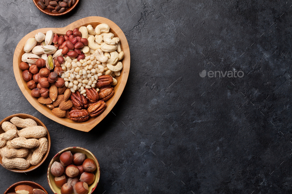 Various nuts selection on stone table - Stock Photo - Images