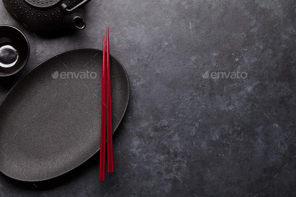 Empty plate, cup, teapot and chopsticks - Stock Photo - Images