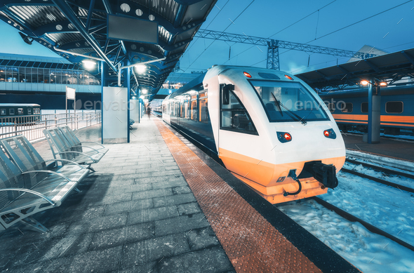 High speed train on the railway station at night - Stock Photo - Images