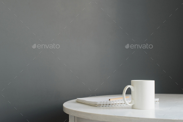 white ceramic coffee cup with notepad and pencil on wooden table - Stock Photo - Images