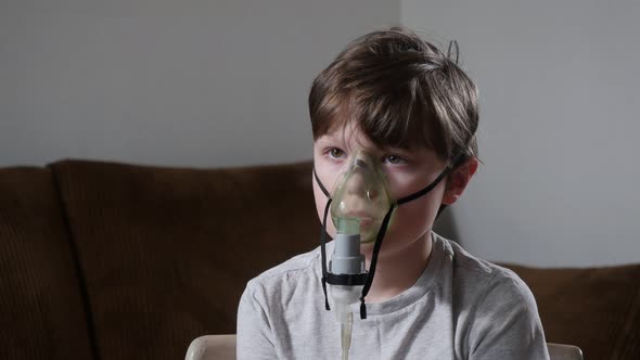 Little Kid Using Nebulizer During Inhalation Therapy Procedure