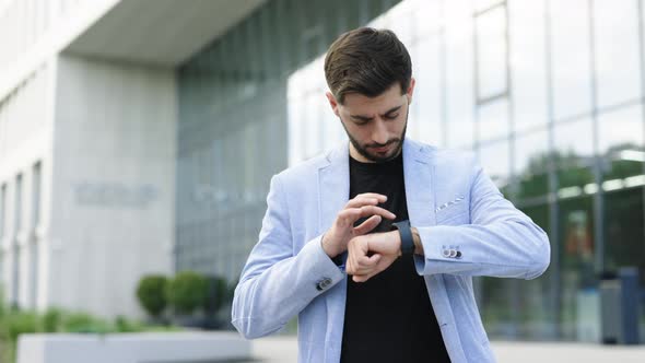 Businessman Scrolling On Display On Smartwatch Notification