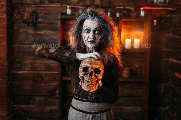 Witch reads the spell, ritual with human skull - Stock Photo - Images