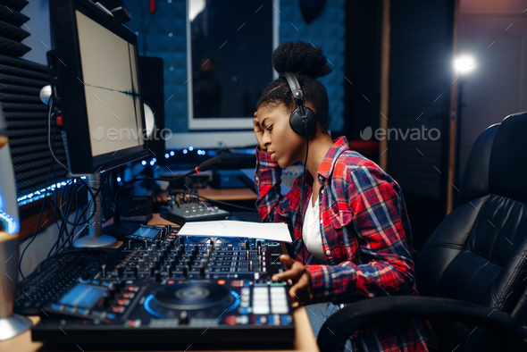 Female sound operator in audio recording studio