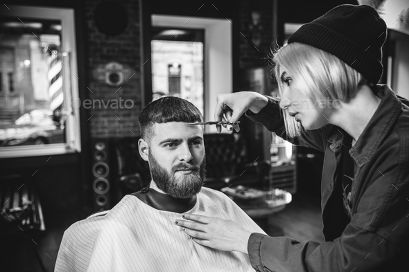 Client during beard shaving in barber shop - Stock Photo - Images