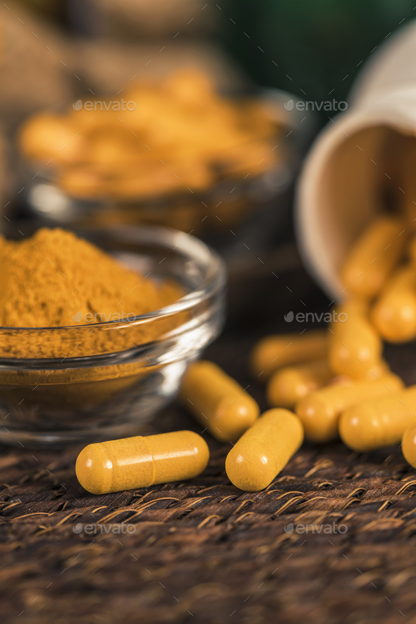 Curcumin Herbal Supplement Capsules and Turmeric Powder - Stock Photo - Images
