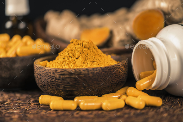 Curcumin Herbal Supplement Capsules and Turmeric Powder - Stock Photo - Images