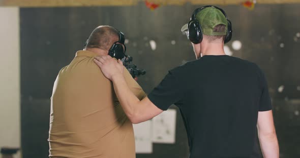 The Stressed Student Fires the First Shot From the Rifle at the Shooting Range alt
