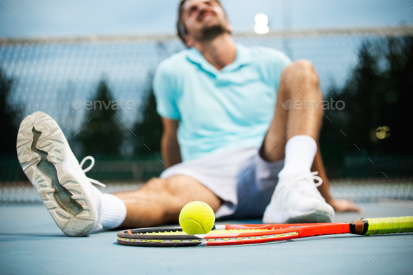 Tired tennis player man on tennis court with racket - Stock Photo - Images