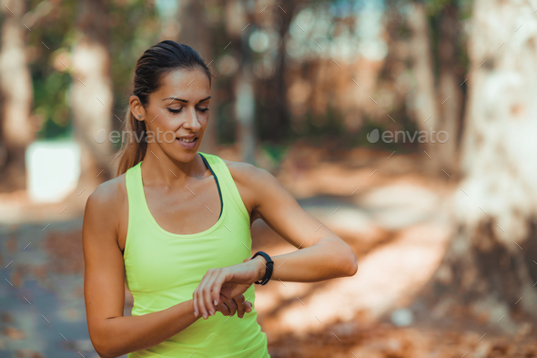 Woman Looking At Smart Watch After Outdoor Training Stock