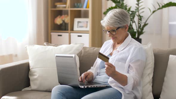 Senior Woman with Laptop and Credit Card at Home  alt