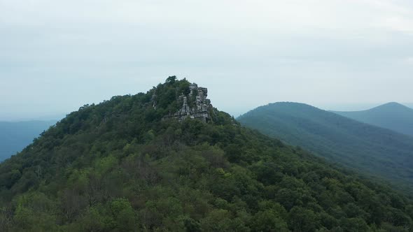 An aerial shot (dolly in, pedestal up) of Big Schloss and Great North Mountain in the evening in the alt