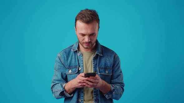 Happy Man Typing Sms on Blue Background