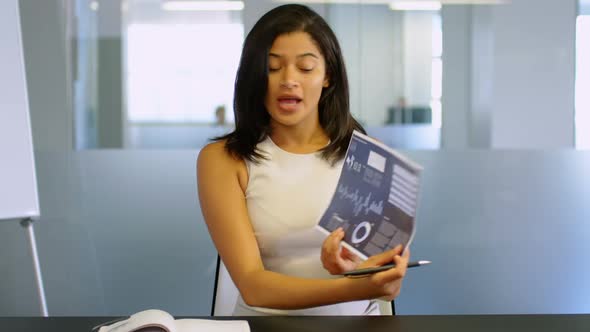 Businesswoman explaining chart in a modern office 4k alt