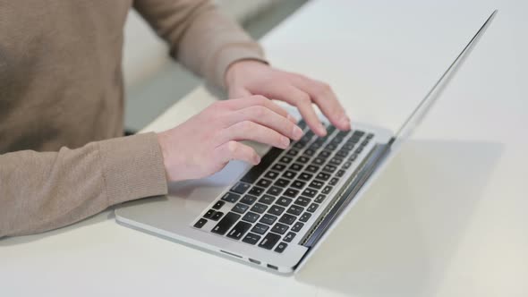 Hands Close Up of Man Typing on Laptop alt