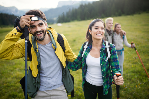 Fotografia do Stock: Group of young friends hiking in countryside