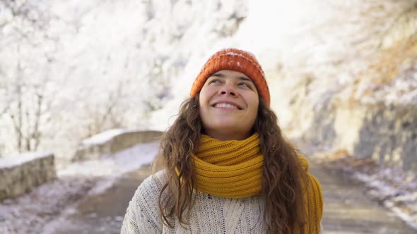 Smiling Brunette Walks Road Along Winter Forest