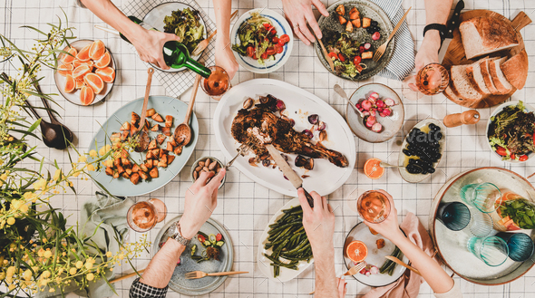 Flat-lay of hands of people eating and drinking rose wine - Stock Photo - Images