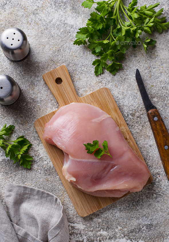 Raw Chicken Breast On A Wooden Cutting Board Stock Photo, Picture and  Royalty Free Image. Image 27433651.