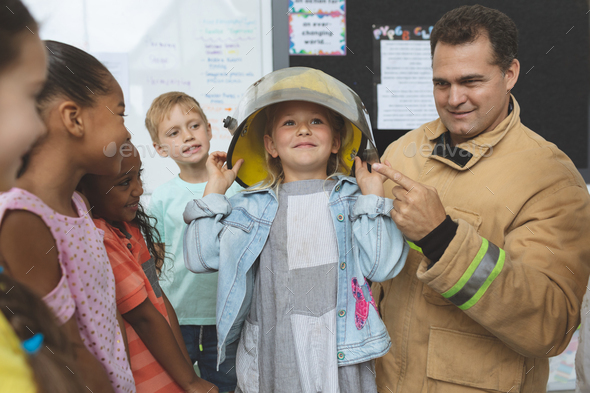 Firefighter teaching to school kids about fire security