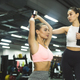 Workout with personal trainer. Instructor helping girl in gym Stock Photo  by Prostock-studio