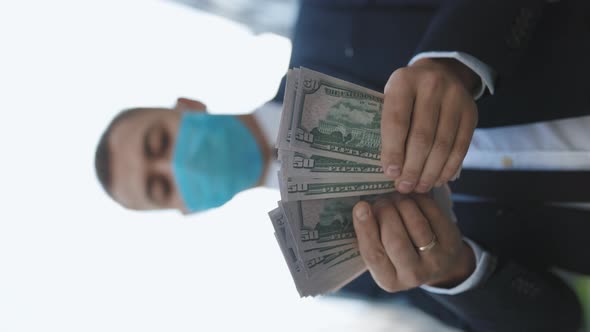 Young Handsome Rich Man Wearing Stylish Suit Counting Money Standing near Office Building alt