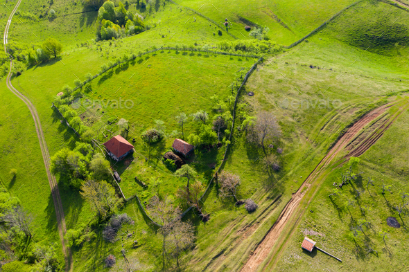Aerial view of a countryside homestead houses in the mountains by drone - Stock Photo - Images
