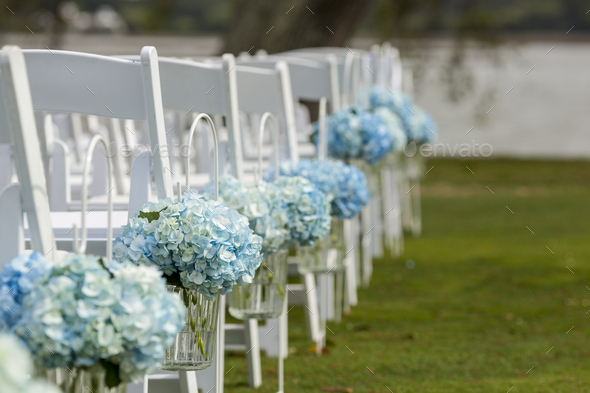 Bouquets Of Hydrangeas Hanging From Chairs For Outdoor Wedding
