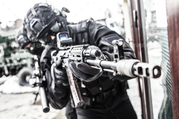 Police special reaction team member aims with gun - Stock Photo - Images